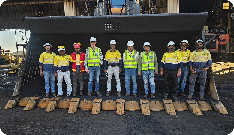Voltas maintenance team in front of a mining excavator bucket